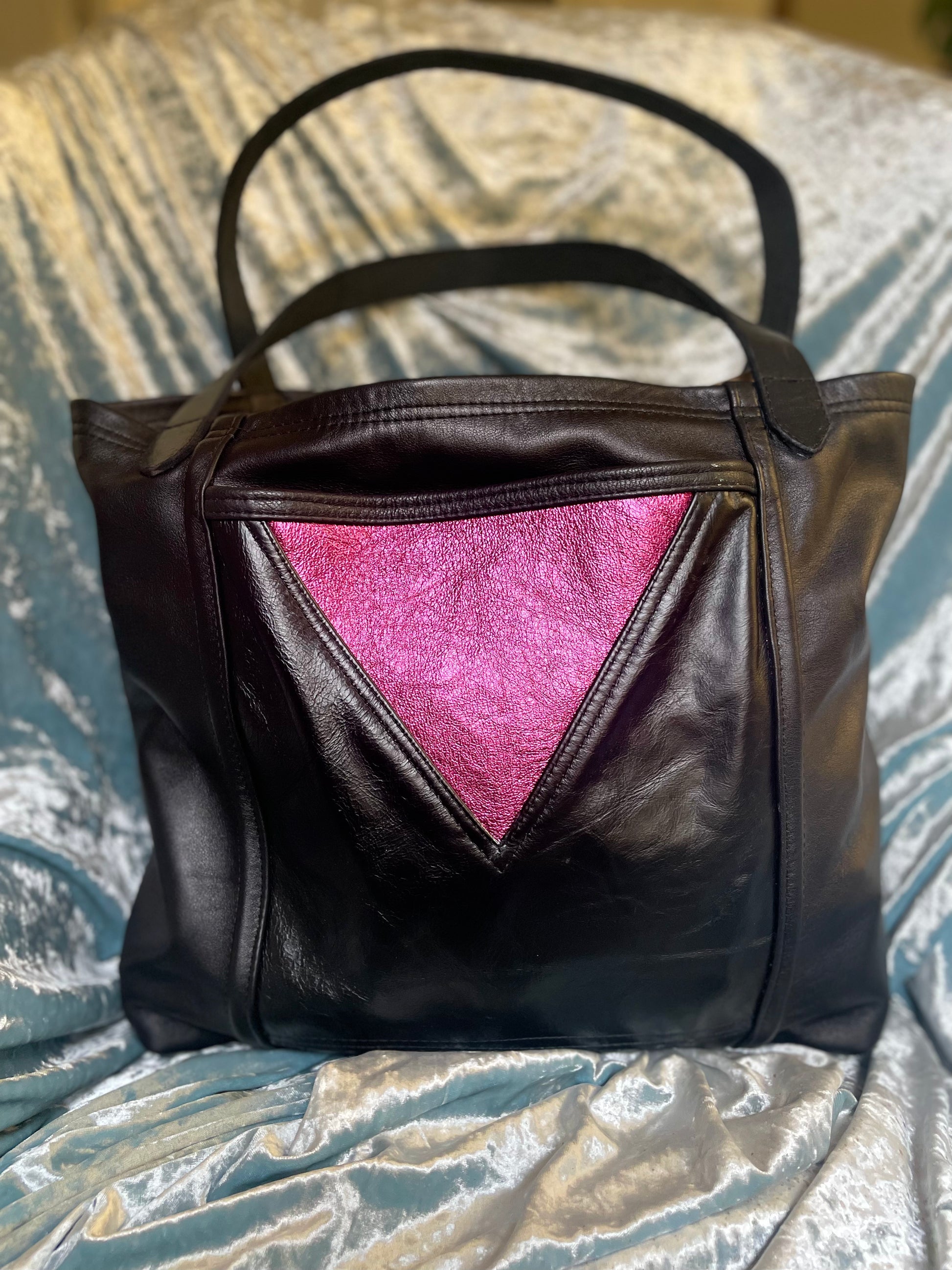 Black leather bag with metallic fuchsia triangle detail