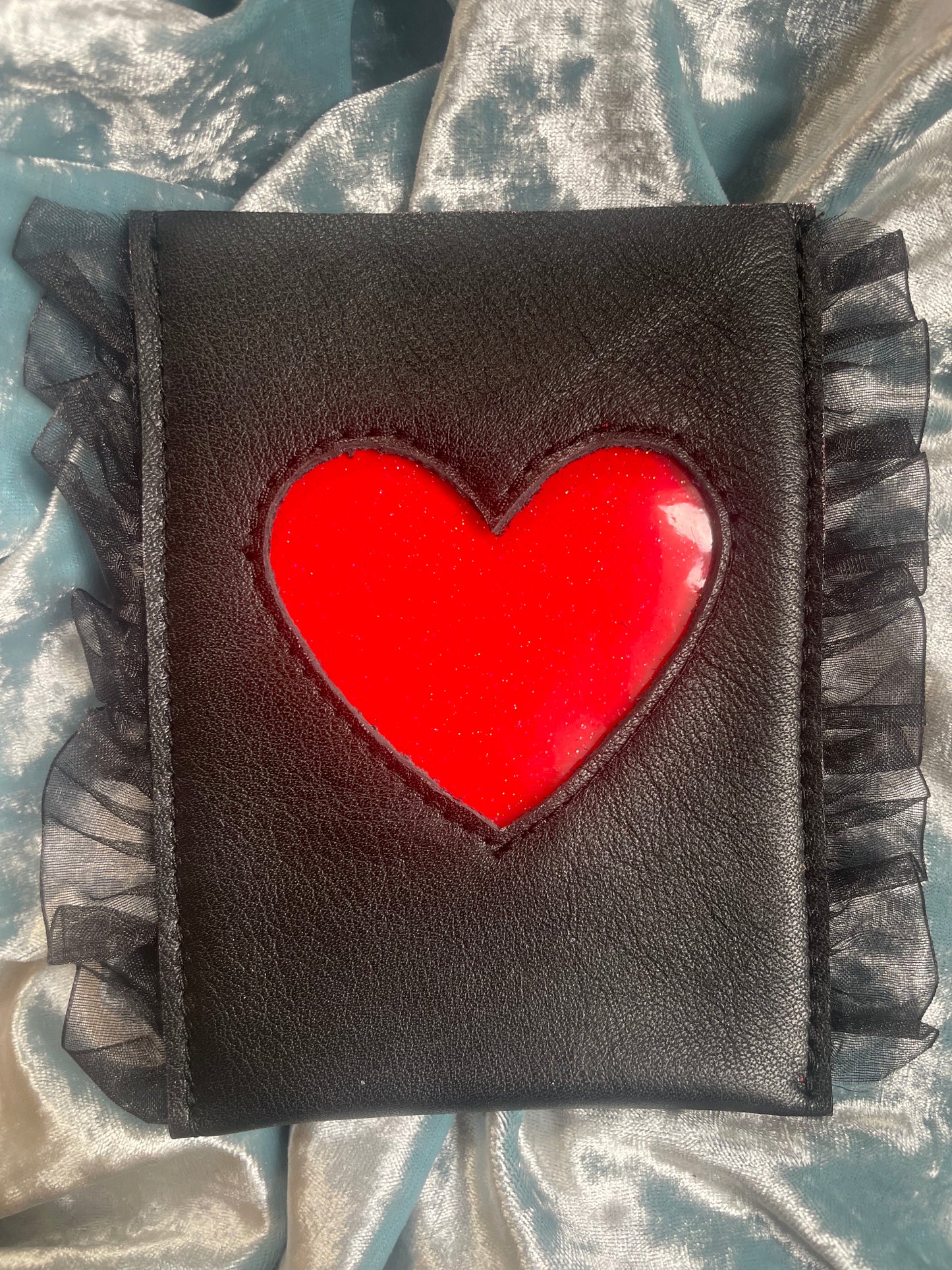 black leather, red vinyl heart, black ruffles